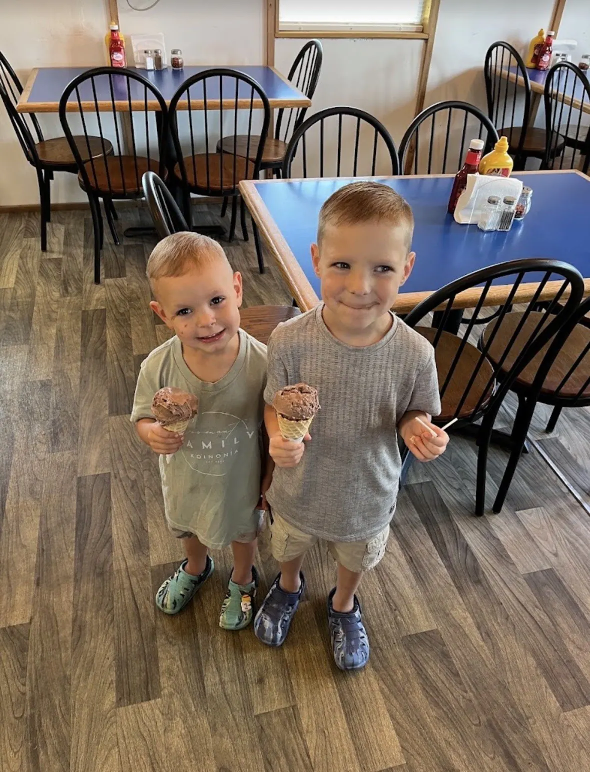 Two young boys eating ice cream